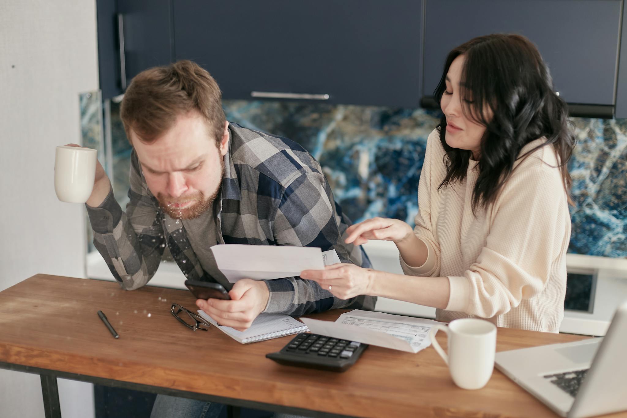 Home A Couple Sitting At A Desk Reviewing Bills And Expenses With A Calculator And Laptop Looking Worried. 6964355 2048x1365