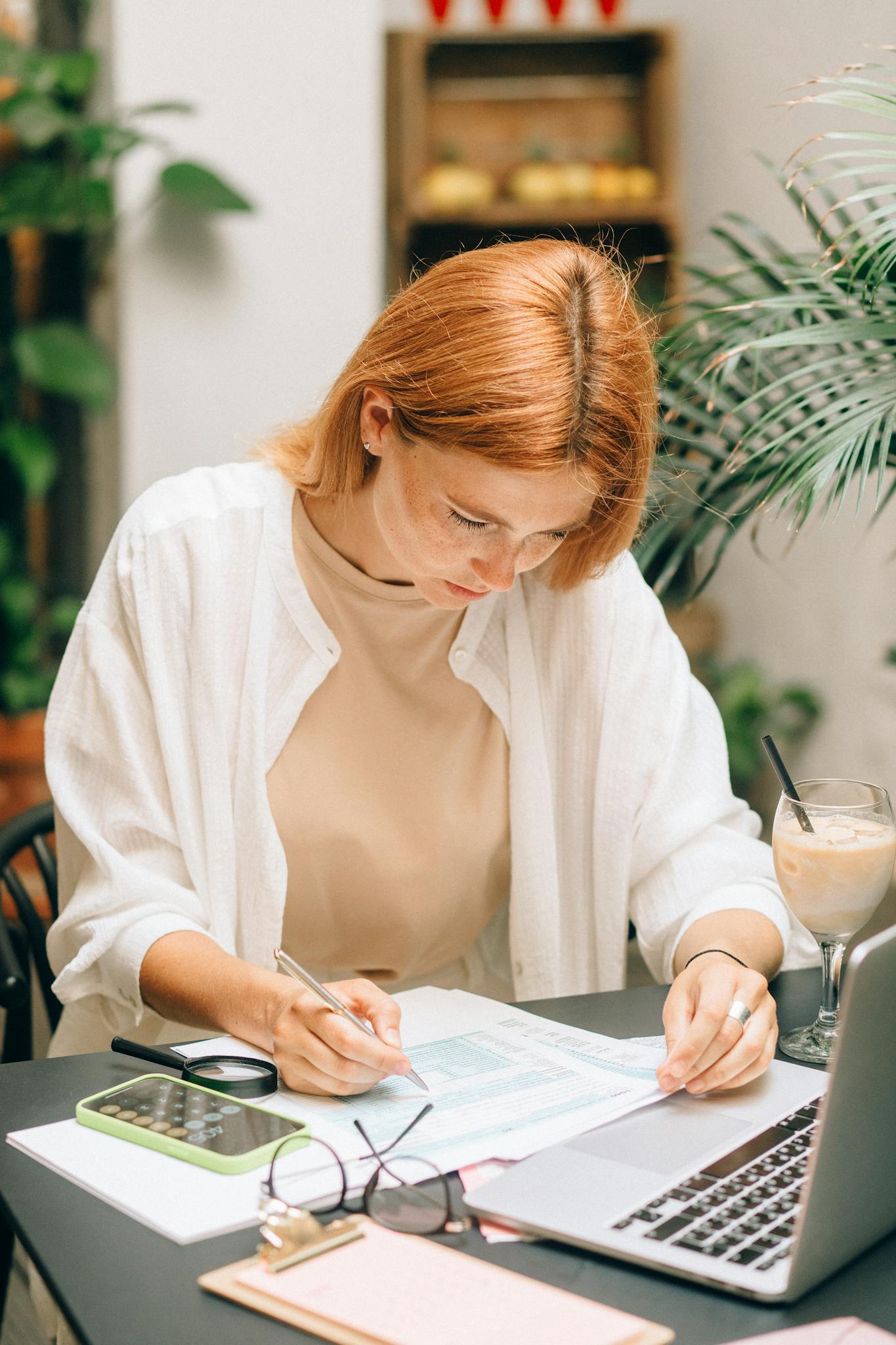 Home Woman Analyzing Financial Documents Using Laptop And Calculator Indoors. 8927463 1365x2048